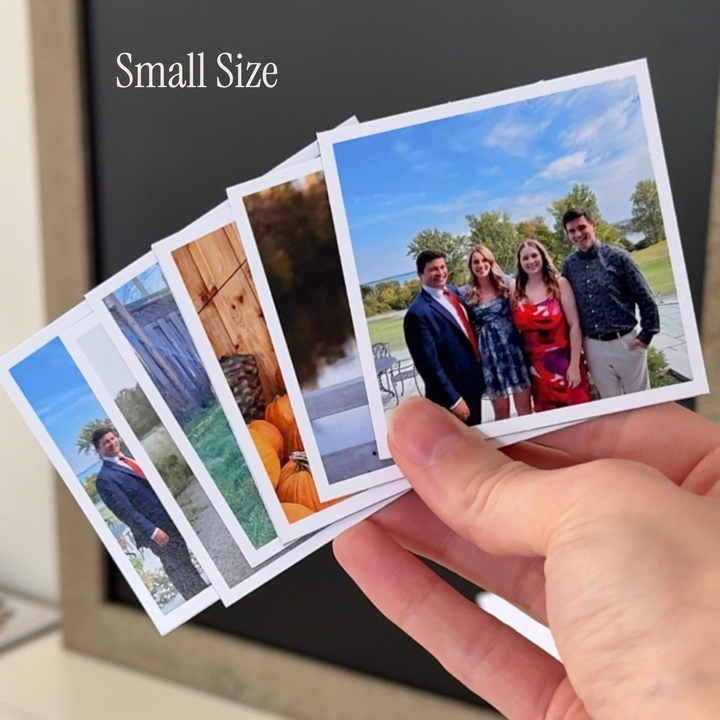 Hand holding a set of small 2.75-inch square flexible photo magnets