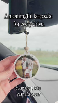Swapping the removable photo magnet in an interchangeable car ornament